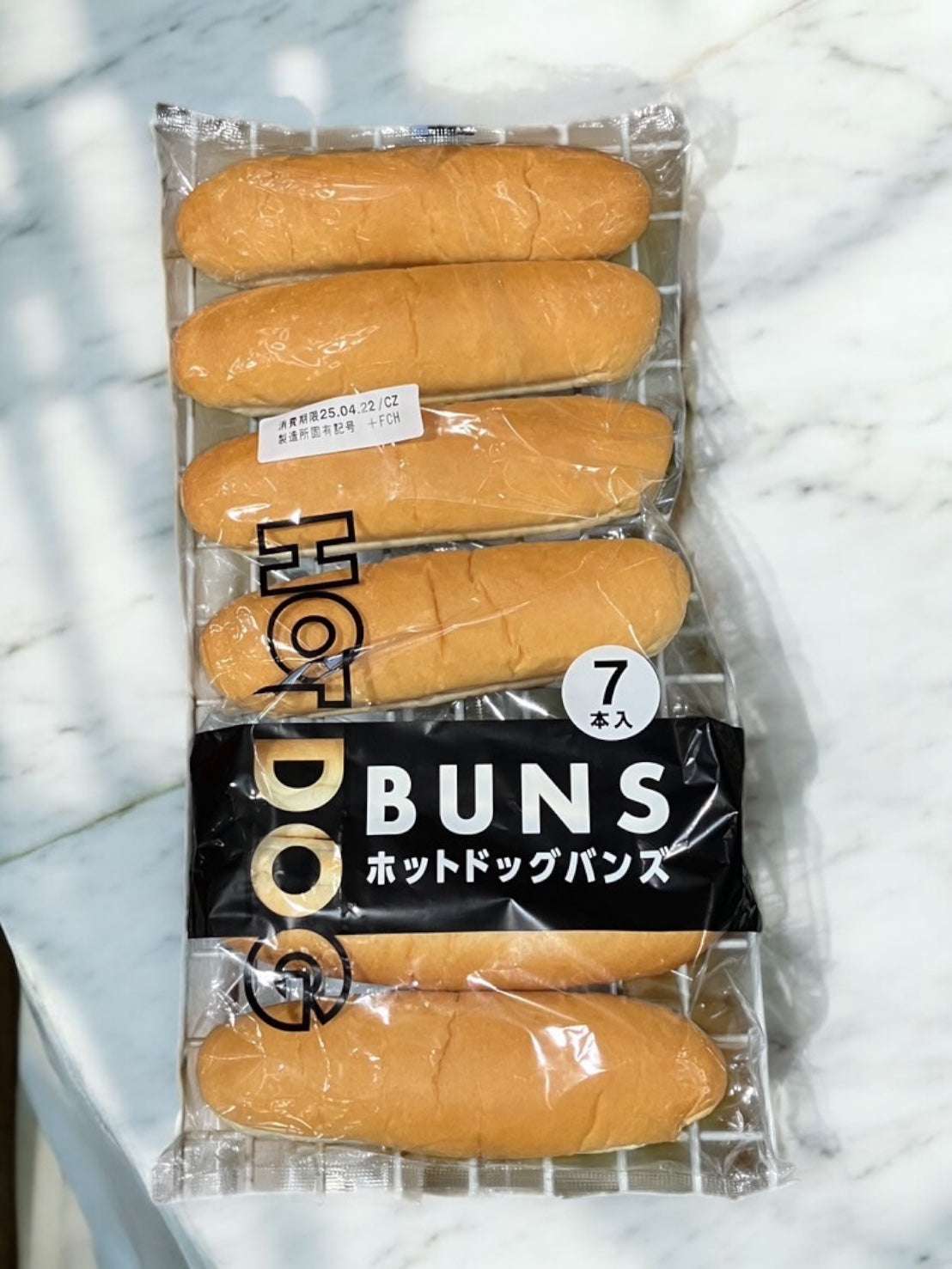 HOT DOG BUNS packaged on a marble surface, featuring a set of seven buns.