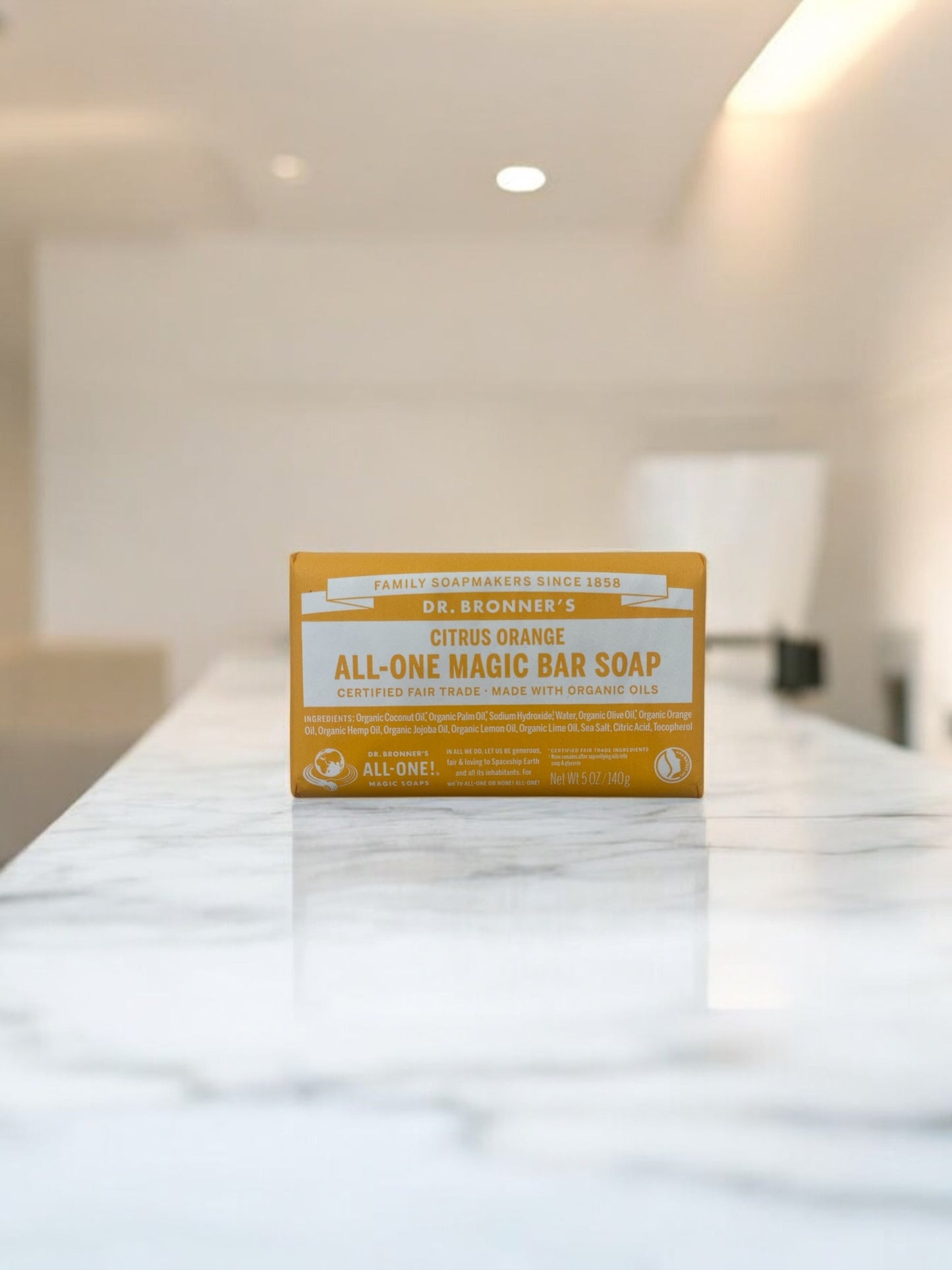 Dr. Bronner's Organic Magic Bar Soap Citrus Orange 140g on marble surface.