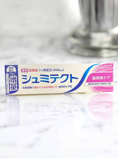 薬用シュミテクト 歯周病ケア 増量パック 100g toothpaste on marble surface.