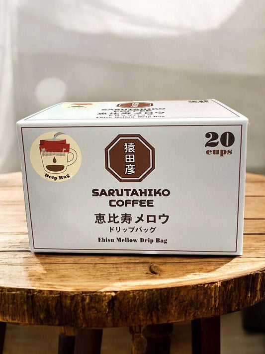 Sarutahiko Coffee Ebisu Mellow Drip Bag 20-Pack on wooden table.