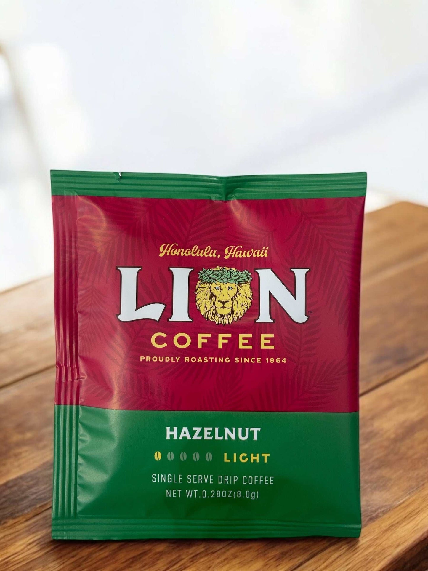 LION COFFEE Hazelnut Flavored Drip Bag on Wooden Surface