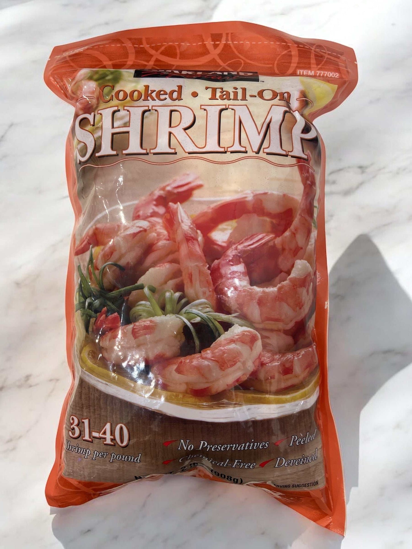 Frozen peeled cooked tail-on shrimp size 31-40 by Kirkland Signature in resealable orange bag