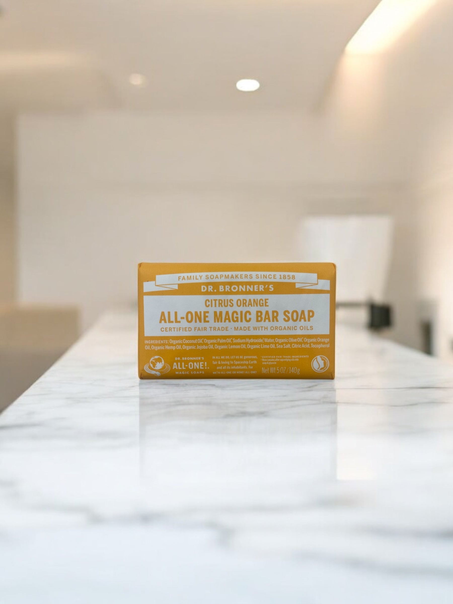 Dr. Bronner's Organic Magic Bar Soap Citrus Orange 140g on marble surface.
