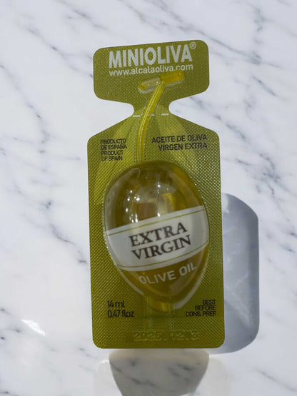MINIOLIVA extra virgin olive oil portion pack on a marble surface, high-quality Spanish origin.