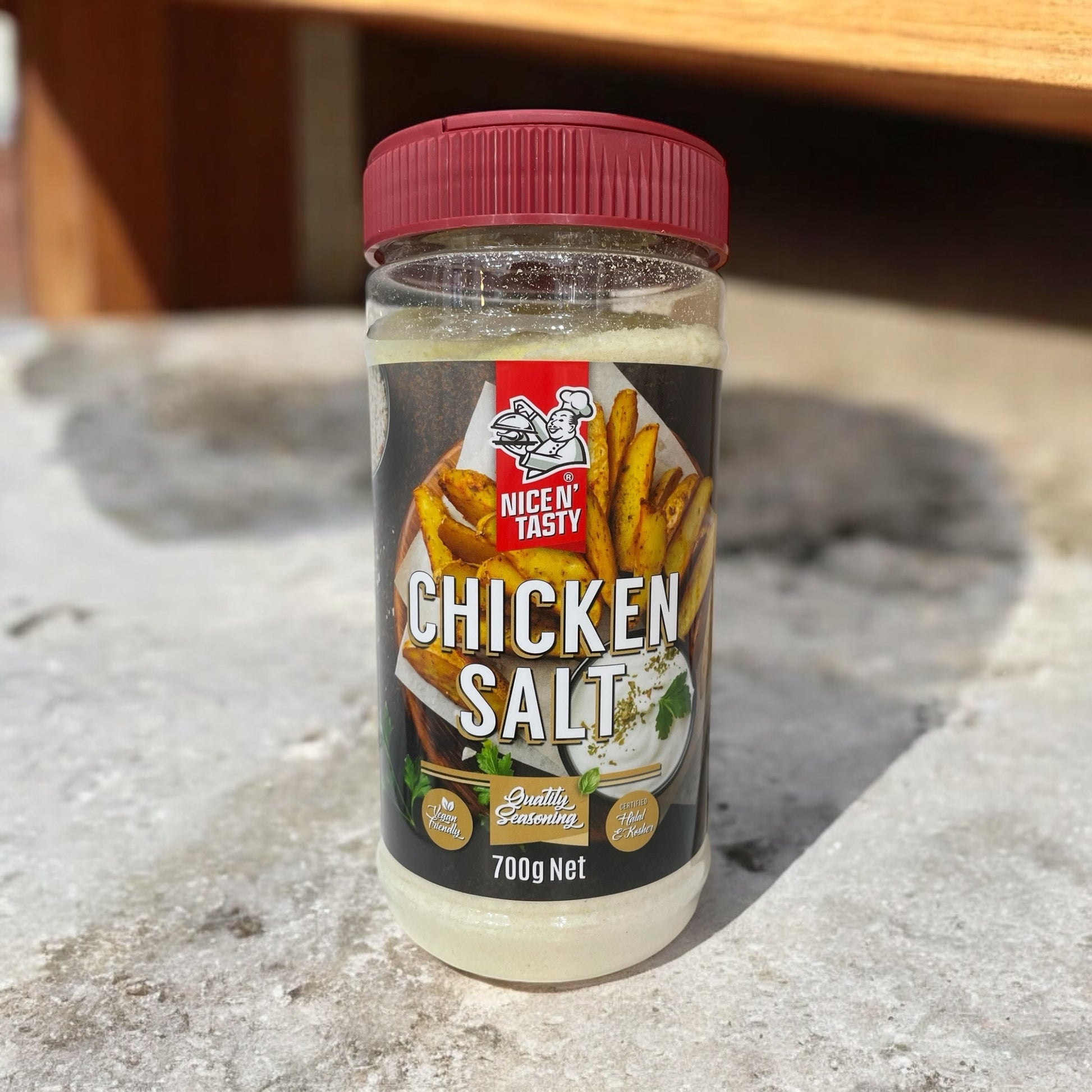 NICE N TASTY Chicken Salt 700g seasoning bottle on a stone surface, herb and spice blend.