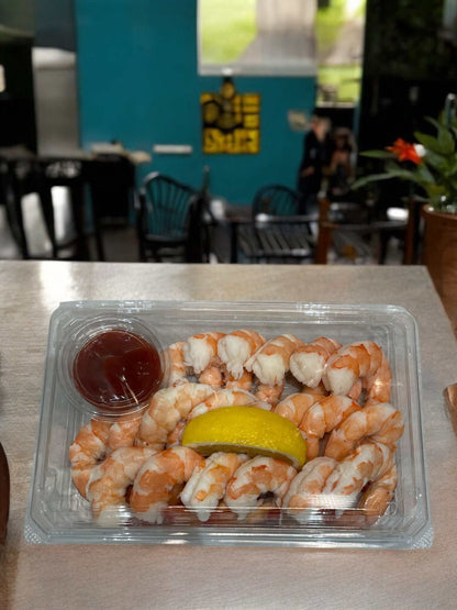 Shrimp cocktail pack with about 20 steamed shrimp, cocktail sauce, and lemon wedge for 2-3 servings
